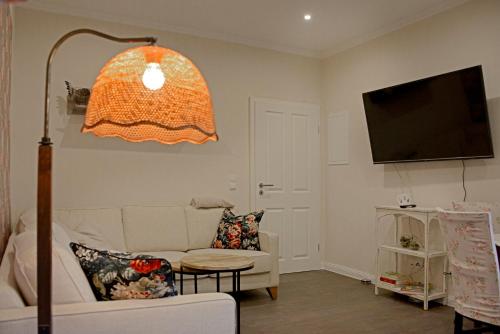 a living room with a couch and a flat screen tv at Ferienwohnungen Bauernschmause in Polch