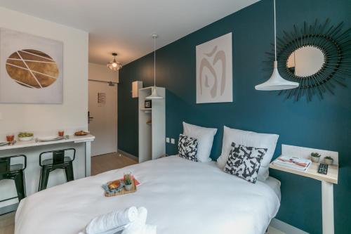 a bedroom with a large bed with blue walls at WS Tour Eiffel - Nicolo in Paris