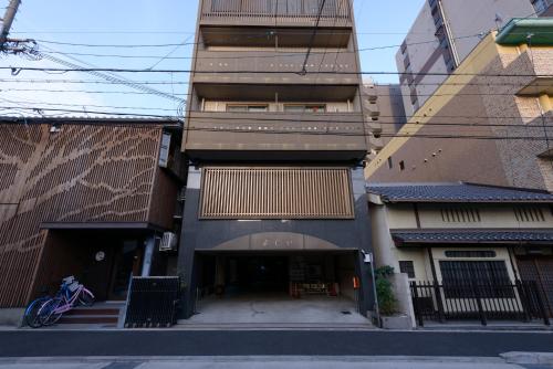 a building on a street with a bike parked in front at Kyoto Yoshii House in Kyoto