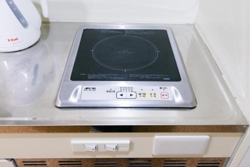 an electronic device sitting on top of a shelf at Kyoto Yoshii House in Kyoto