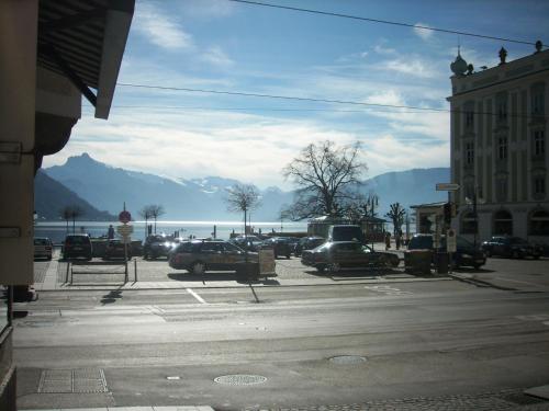 a parking lot with cars parked in front of the water at Garconniere im ehemaligen Hotel Austria in Gmunden