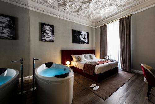 a bedroom with a bed and a bath tub and a bed and a tub at Growel Exclusive Suites San Pietro in Rome