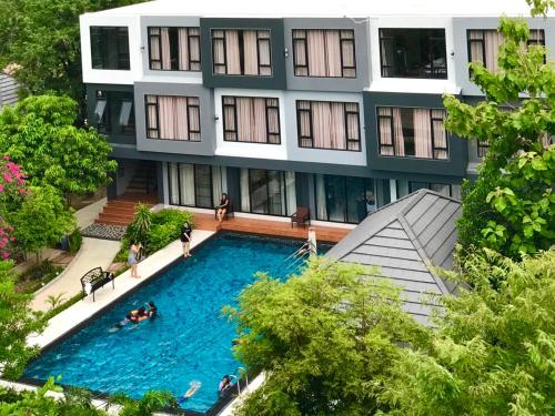 a building with a swimming pool in front of it at Midtown Sukhothai in Sukhothai