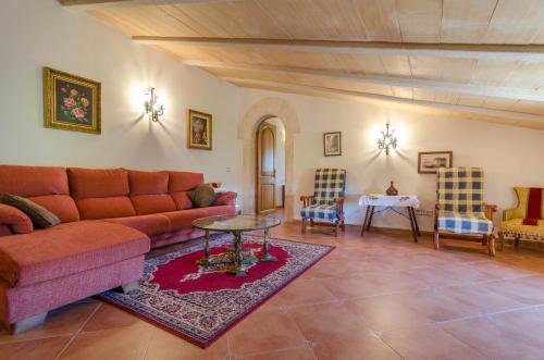 a living room with a couch and a table and chairs at Can Gallot De Punxuat in Algaida
