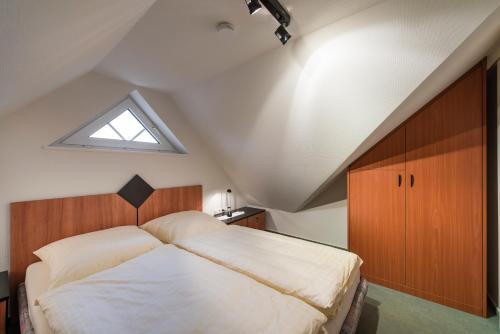 a bedroom with a large bed in a attic at Haus Elbstrom, Whg. 26 in Cuxhaven