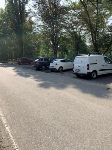 a group of cars parked on the side of a street at San Donato Policlinico BBking in San Donato Milanese
