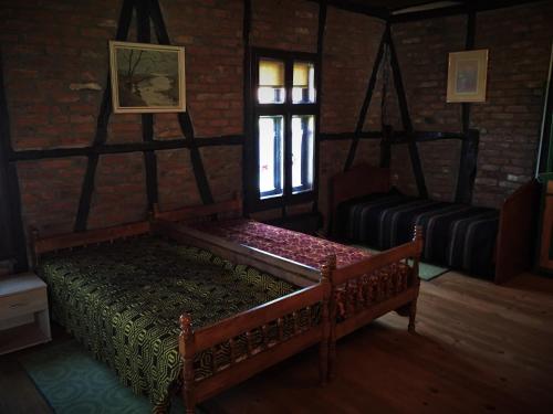 a living room with two beds and a window at Etno Kuća - Rakić in Svrljig