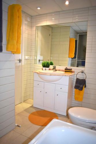a bathroom with a sink and a toilet and a mirror at ROCASOL - Beach in Calpe