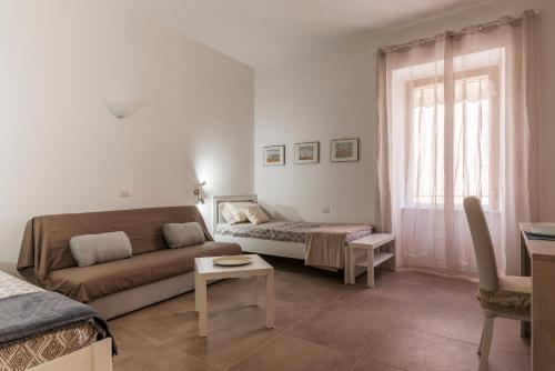 a living room with a couch and a bed at San Lorenzo Modern Flat in Rome