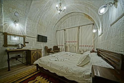 Ένα ή περισσότερα κρεβάτια σε δωμάτιο στο Cappadocia Fairy Tale Suites