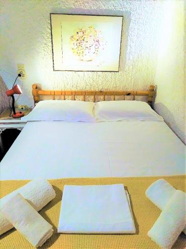 a bedroom with a bed with two towels on the floor at Dialiskari #3 in Limniónas