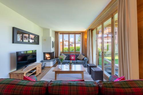 ein Wohnzimmer mit einem Sofa und einem Tisch in der Unterkunft Chalet Balthazar in Villars-sur-Ollon