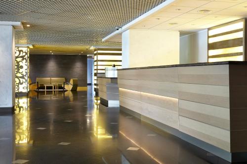 a lobby with a reception desk in a building at Crowne Plaza Milan Linate by IHG in San Donato Milanese