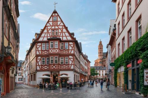 an old building with a tower in a city street at Super 8 by Wyndham Mainz Zollhafen in Mainz