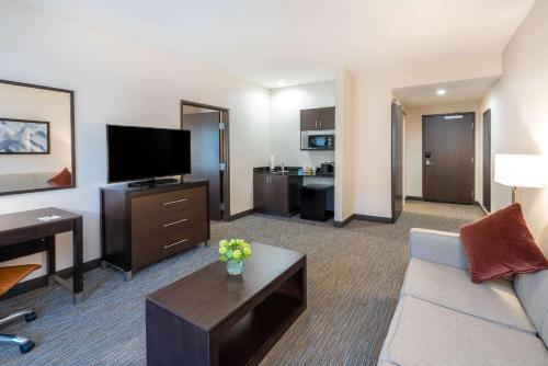 a living room with a couch and a flat screen tv at Wingate by Wyndham Moab in Moab