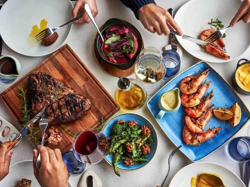 a group of people sitting at a table with food at Fairmont Rio de Janeiro Copacabana in Rio de Janeiro
