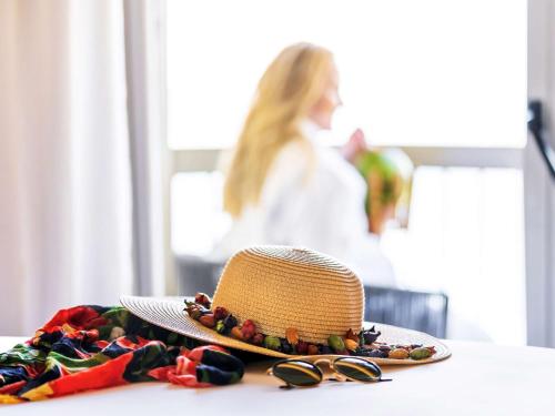 a straw hat and sunglasses sitting on a table at Fairmont Rio de Janeiro Copacabana in Rio de Janeiro