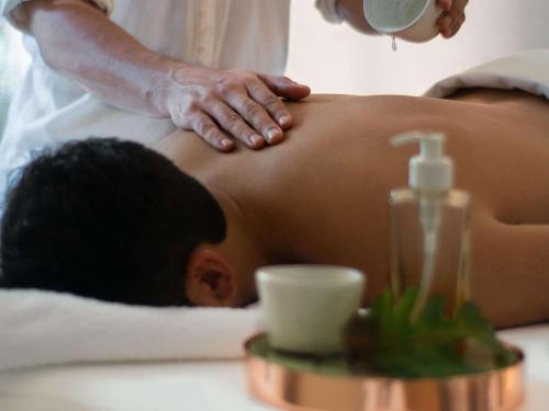a man getting a massage from a therapist at Fairmont Rio de Janeiro Copacabana in Rio de Janeiro