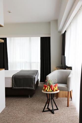 a hotel room with a bed and a table with fruit on it at Luis Otel in Izmir
