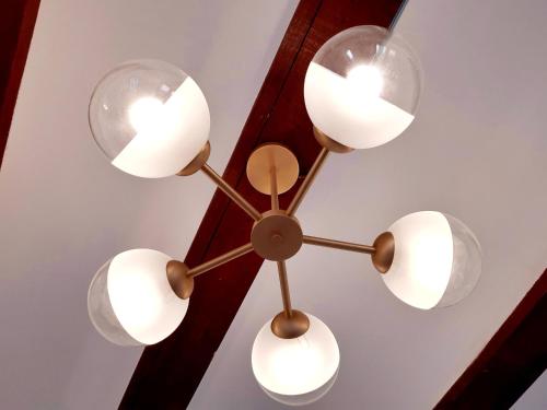 a chandelier hanging from a ceiling with four lights at Hotel 19-30 Valencia in Valencia
