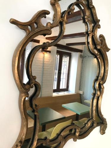 a mirror hanging on a wall with a table at Hotel 19-30 Valencia in Valencia