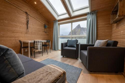 a living room filled with furniture and a window at Eliassen Rorbuer in Reine