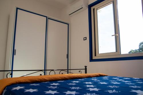 a bedroom with a bed and a window at Taormina Isola bella suite in Taormina
