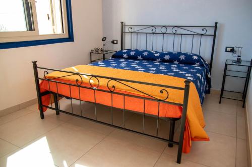 a bedroom with a bed with an orange blanket at Taormina Isola bella suite in Taormina