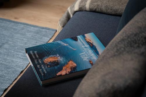 a book sitting on top of a couch at Eliassen Rorbuer in Reine