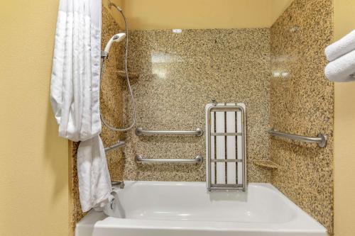 a bathroom with a white tub and a shower at Comfort Suites Frisco in Frisco