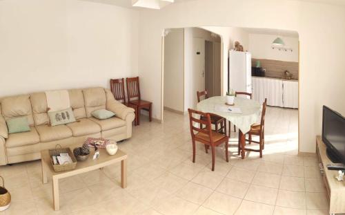 a living room with a couch and a table at LE CLOS VARNAY in Meusnes