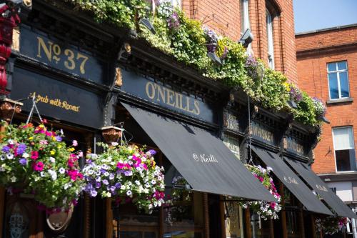 a building with flowers on the side of it at O'Neills Victorian Pub & Townhouse in Dublin