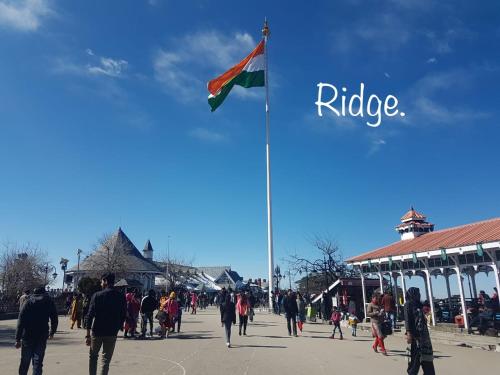 a flag with the word ride on a flag pole at Sai Cottage Shimla in Shimla