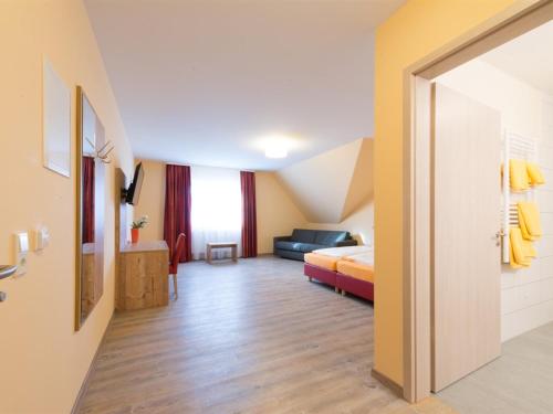 a hotel room with a bed and a couch at Landgasthof Schwarzes Roß in Ansbach