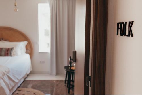 an open door to a bedroom with a bed and a table at Joy Beach House in São Pedro de Moel