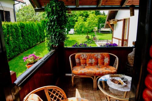 a patio with a couch and a table and chairs at Apartments Predah, Mijaila Radovica 13a in Zlatibor
