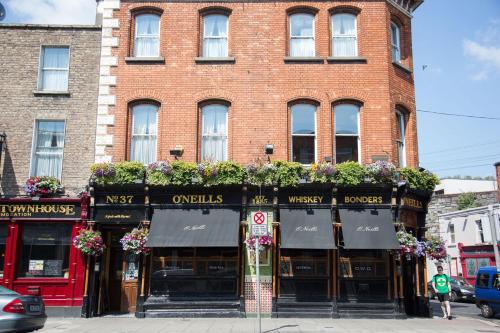 a brick building with plants on the front of it at O'Neills Victorian Pub & Townhouse in Dublin