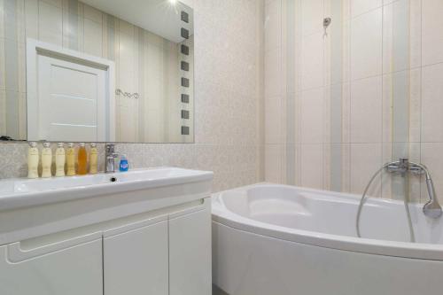 a white bathroom with a tub and a sink at Lux Most City Area, Panoramic city View in Dnipro