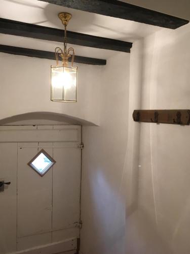 a room with a white door and a light at Ferienwohnung Jacobshof in Oberstedem