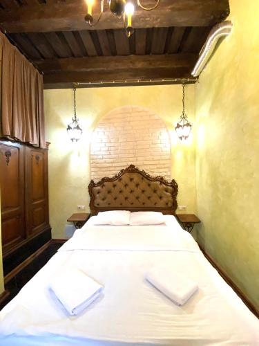 a bedroom with a bed with two white towels on it at Квартира подобово на Площі Ринок 39 in Lviv