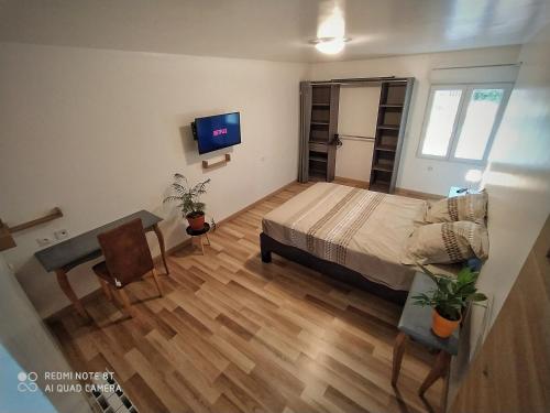 um quarto com uma cama e uma televisão em Domaine les Béseaudières em Le Haut des Bordes