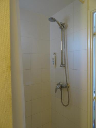 a shower with a shower head in a bathroom at ibis budget Vienne Sud in Vienne