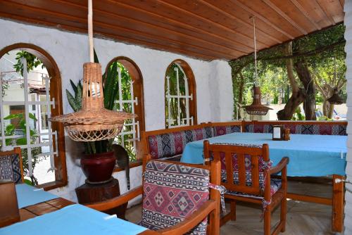 a dining room with a blue table and chairs at Aquarius Hotel in Side