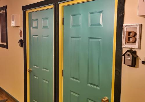 a green and blue door in a room at Bluebird Hotel in Fujikawaguchiko