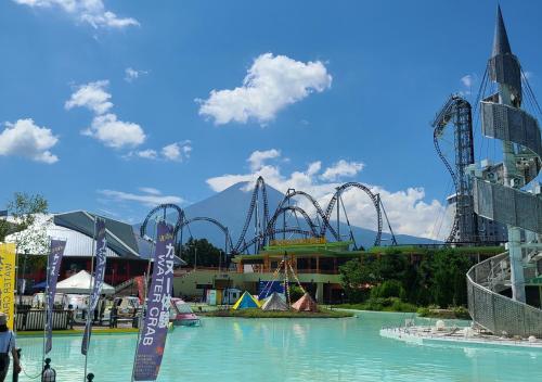 an amusement park with a roller coaster in the water at Bluebird Hotel in Fujikawaguchiko