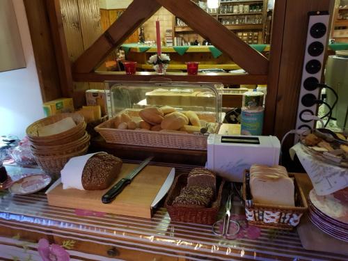 a counter with some bread and baskets of food at Hiasl Stubn in Donnersbach
