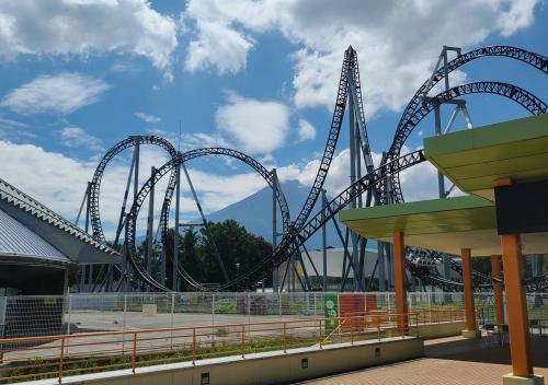 a roller coaster at a theme park on a cloudy day at Bluebird Hotel in Fujikawaguchiko