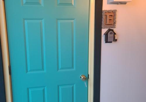 a blue door with a mailbox next to it at Bluebird Hotel in Fujikawaguchiko