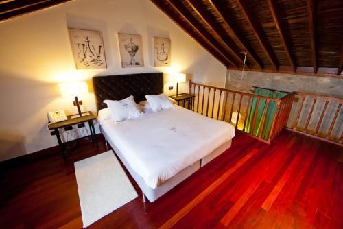 En eller flere senger på et rom på Hotel Rural Hacienda del Buen Suceso