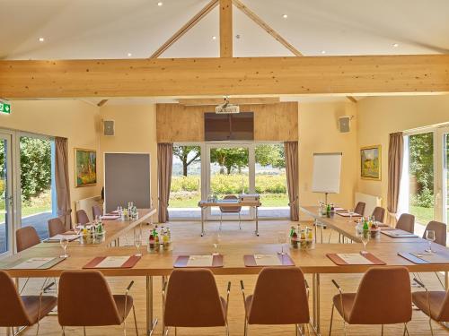 a large conference room with a large table and chairs at Parkhotel Bad Griesbach in Bad Griesbach